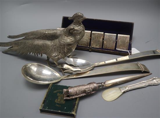 A cased set of six plated napkin rings and other items including pair pheasants and salad servers.
